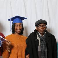 A graduate and family poses at GradFest